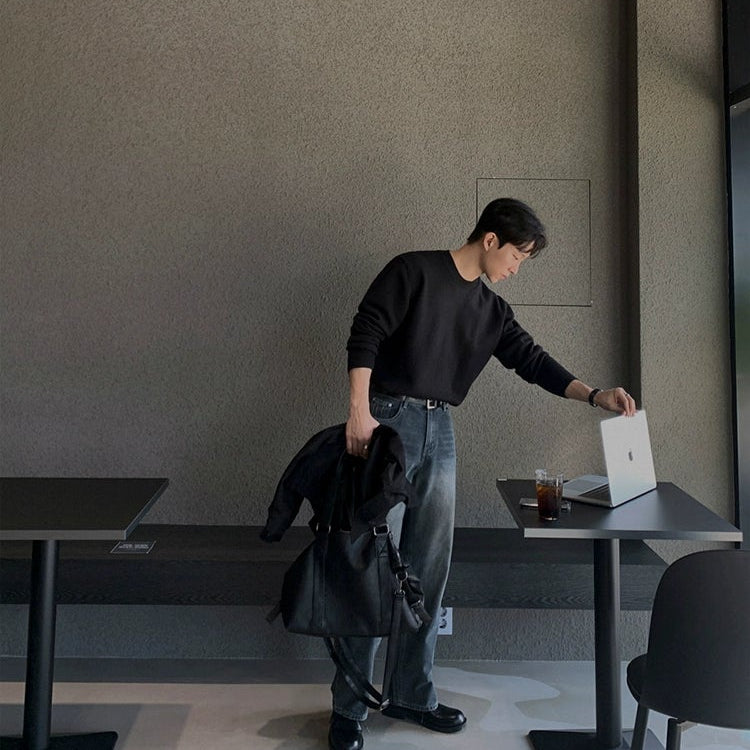 Person in a casual setting with a laptop and jacket.
